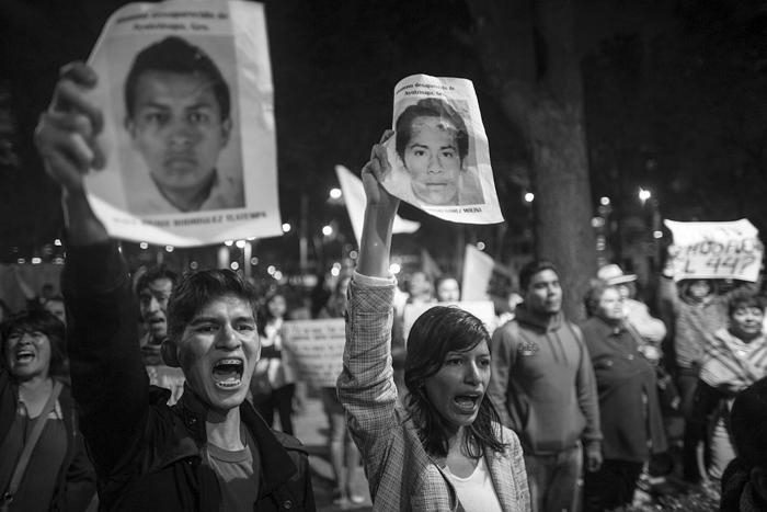 MEXICO CITY, MEXICO - NOVEMBER 08: People protest outside the Mexican Attorney General's office during a spontaneous demonstration after Mexico's government announced on friday that evidence suggests that 43 missing students were murdered and their charred remains tipped in a rubbish dump and a river in Guerrero, Mexico, on November 08, 2014 in Mexico City, Mexico. (Photo by Miguel Tovar/LatinContent/Getty Images)