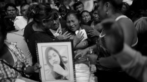 A woman cries during the funeral of Siona Hernandez, a victim of a fire at the Virgen de Asuncion children shelter, at the cemetery in Guatemala City